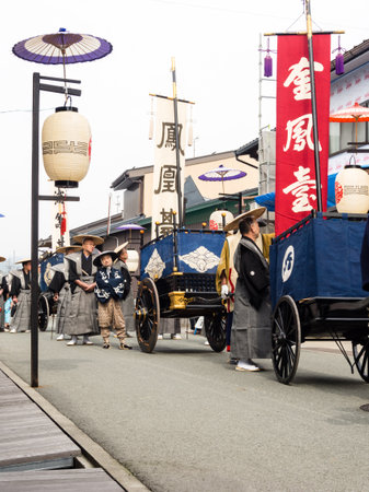Takayama, Japan - October 10, 2015: Local people in traditional costumes marching the streets of historic Takayama during the annual Takayama Autumn Festival paradeのeditorial素材
