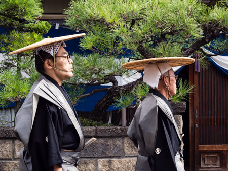Takayama, Japan - October 10, 2015: Two local men dressed in traditional historical costumes on the streets of Takayama during the annual Takayama Autumn Festival paradeのeditorial素材