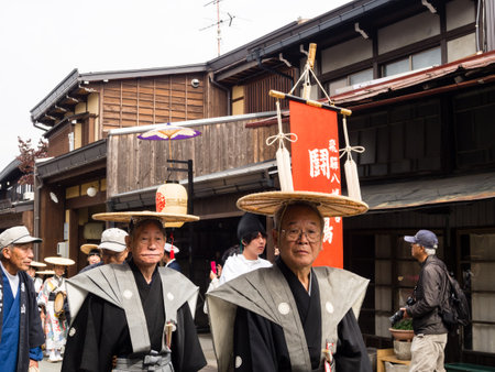 Takayama, Japan - October 10, 2015: Local people in traditional costumes marching the streets of historic Takayama during the annual Takayama Autumn Festival paradeのeditorial素材