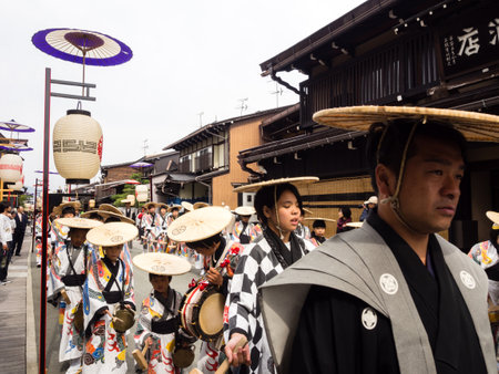 Takayama, Japan - October 10, 2015: Local people in traditional costumes marching the streets of historic Takayama during the annual Takayama Autumn Festival paradeのeditorial素材
