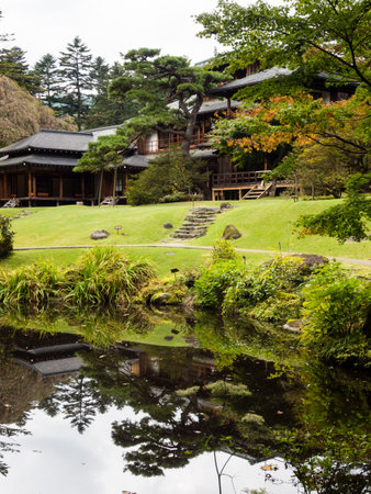 Nikko, Japan - October 23, 2016: Traditional Japanese landscape garden with pond in Tamozawa Imperial Villa with fall leaves starting to change colorのeditorial素材