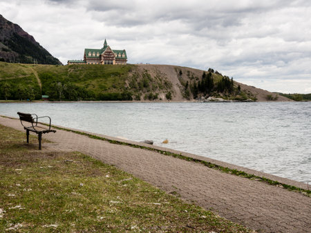 Waterton Lakes National Park, Canada - July 6, 2016: Waterton Townsite waterfront and historic Prince of Wales hotel under stormy skyのeditorial素材