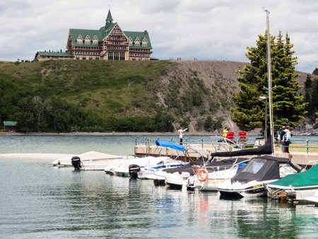 Waterton Lakes National Park, Canada - July 6, 2016: Waterton Townsite waterfront and historic Prince of Wales hotel under stormy skyのeditorial素材