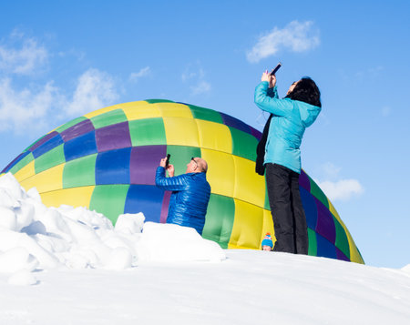 Winthrop, WA / USA - March 4, 2017: Visitors at Winthrop Balloon Festival taking photos of hot air balloons taking offのeditorial素材