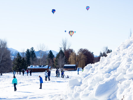 Winthrop, WA / USA - March 4, 2017: Colorful hot air balloons flying above a snow covered field at Winthrop Balloon Festival in Washington state, USAのeditorial素材