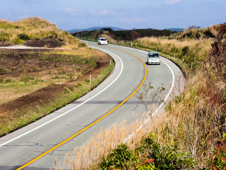 Aso, Japan - November 5, 2016: Cars driving along the north rim of Aso volcanic caldera in Aso-Kuju National Parkのeditorial素材
