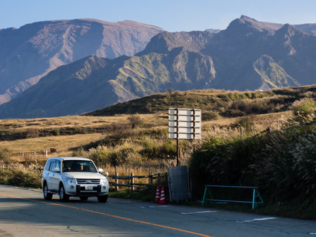 Aso, Japan - November 5, 2016: Car driving along the scenic road in Aso volcanic caldera, part of Aso-Kuju National Parkのeditorial素材