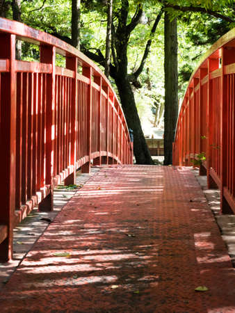 Red bridge across the Togawa river leading to Manji Stone Buddha in Shimosuwa - Nagano prefecture, Japanの写真素材