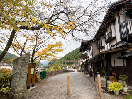 Kiso, Nagano prefecture, Japan - October 23, 2017: Traditional Japanese houses and fall foliage at the entrance to Fukushima Checkpoint Museumのeditorial素材