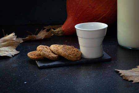 Plate with chocolate chip cookies and glass of milkの写真素材