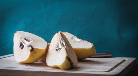 one sliced yellow quince with seedsの写真素材