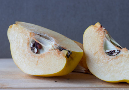 one sliced yellow quince with seedsの写真素材