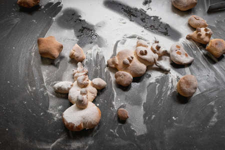 Kids activity with bread dough, baked snowman and other figures