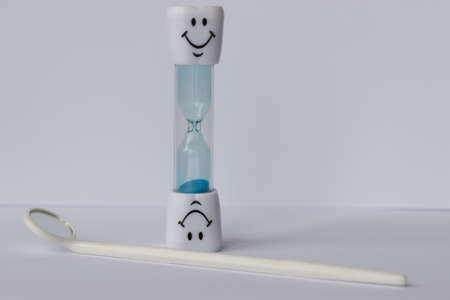hourglass with smile and colored sand pouring
