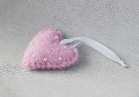 pearls on a pink textured pillowの写真素材