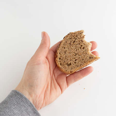 Hand holding piece of bread