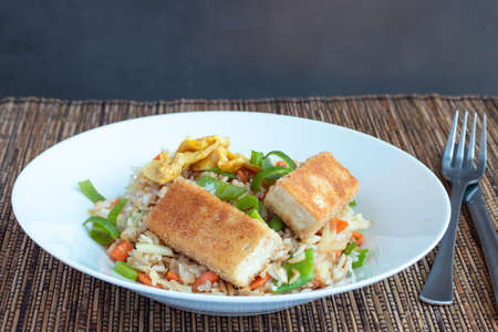 Fried rice with vegetable and tofu in egg and breadcrumbsの写真素材