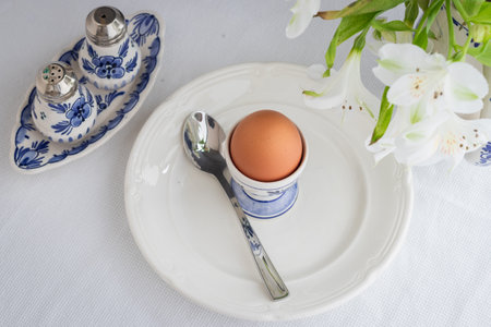 Boiled egg on white and blue Delft porcelainの写真素材