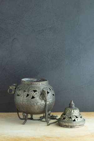 Antique metal incense burner on gray backgroundの写真素材