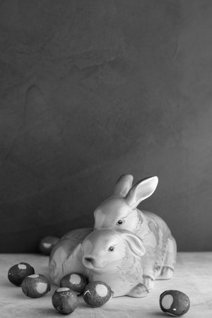 Easter bunnies and easter chocolate eggs on gray backgroundの写真素材