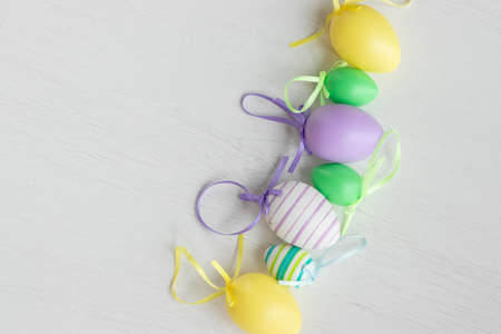 Pastel color plastic Easter eggs decoration on a light background