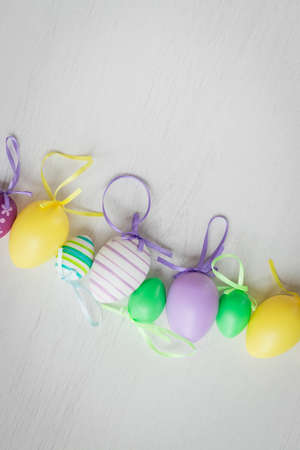 Pastel color plastic Easter eggs decoration on a light backgroundの写真素材