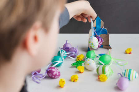 Boy with plastic Easter egg decoration on his handsの写真素材