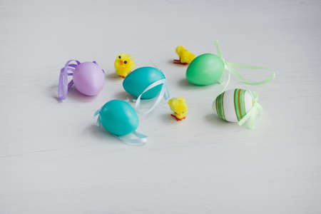 Pastel color plastic Easter eggs decoration on a light backgroundの写真素材