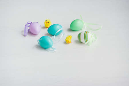 Pastel color plastic Easter eggs decoration on a light background