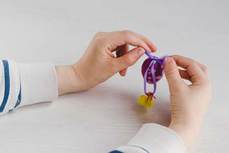 Boy with plastic Easter egg decoration on his handsの写真素材