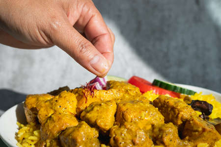 Garnished chicken Madras with Pulao rice in a white bowlの写真素材