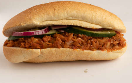Baked cod fish sandwich with salad and red sauceの写真素材