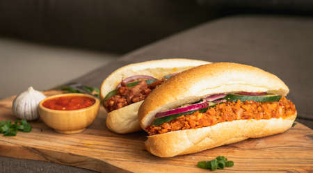 Indian Surinamese sandwiches filled with roti chicken curry, cod fish or tandoori chickenの写真素材