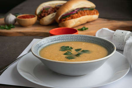 Dahl soup with yellow lentils on a table, lunch or dinningの写真素材