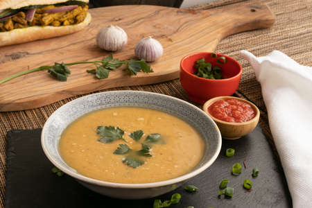Dahl soup with yellow lentils on a table, lunch or dinningの写真素材