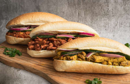 Indian Surinamese sandwiches filled with roti chicken curry, cod fish or tandoori chickenの写真素材
