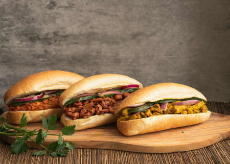 Indian Surinamese sandwiches filled with roti chicken curry, cod fish or tandoori chickenの写真素材