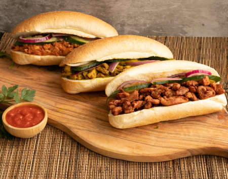 Indian Surinamese sandwiches filled with roti chicken curry, cod fish or tandoori chickenの写真素材