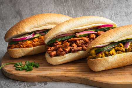 Indian Surinamese sandwiches filled with roti chicken curry, cod fish or tandoori chickenの写真素材