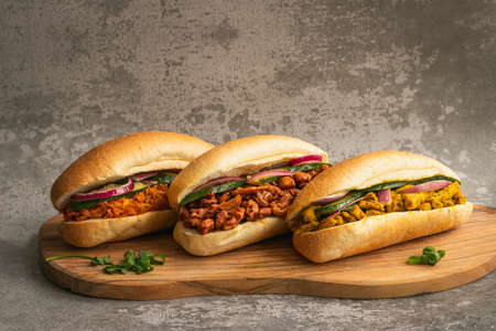 Indian Surinamese sandwiches filled with roti chicken curry, cod fish or tandoori chickenの写真素材