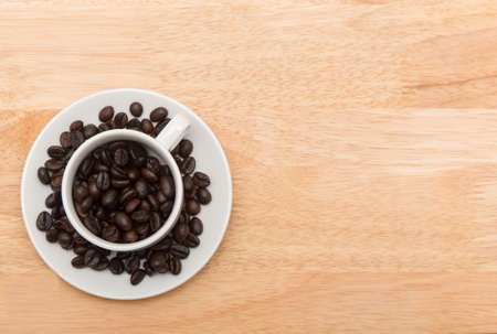 coffee cup with spilled coffee beans, backgroundの写真素材