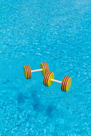 Floating aqua aerobics dumbbell in swimming pool