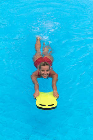 aqua aerobic. Swimmer during practice with board from polyfoam for swimming