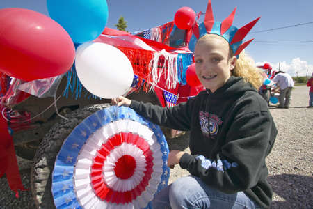 Teenage girl decorating a car in red, white & blue in Lima Montanaのeditorial素材