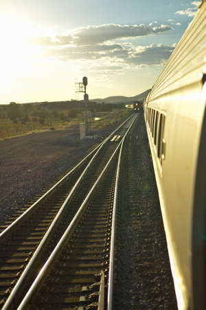 Passenger train traveling into the Arizona sunset