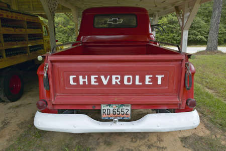 Old red Chevrolet truck in a garage along Highway 22 in Central Georgiaのeditorial素材