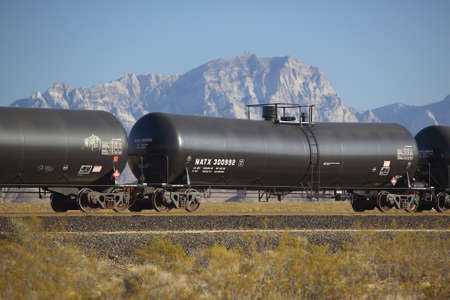 Freight train travels through desert and mountainous areas of Mojave Desert in Southern Californiaのeditorial素材