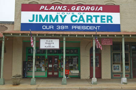 Storefront with banner exclaiming Plains Georgia to be the home of Jimmy Carter, our 39th President in Plains, Georgiaのeditorial素材