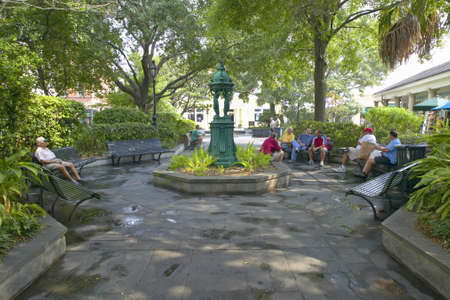 People sitting on benches in French Quarter of New Orleans, Louisianaのeditorial素材