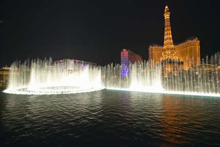 Bellagio Casino Water Show at night with Paris Casino and Eiffel Tower, Las Vegas, NVのeditorial素材